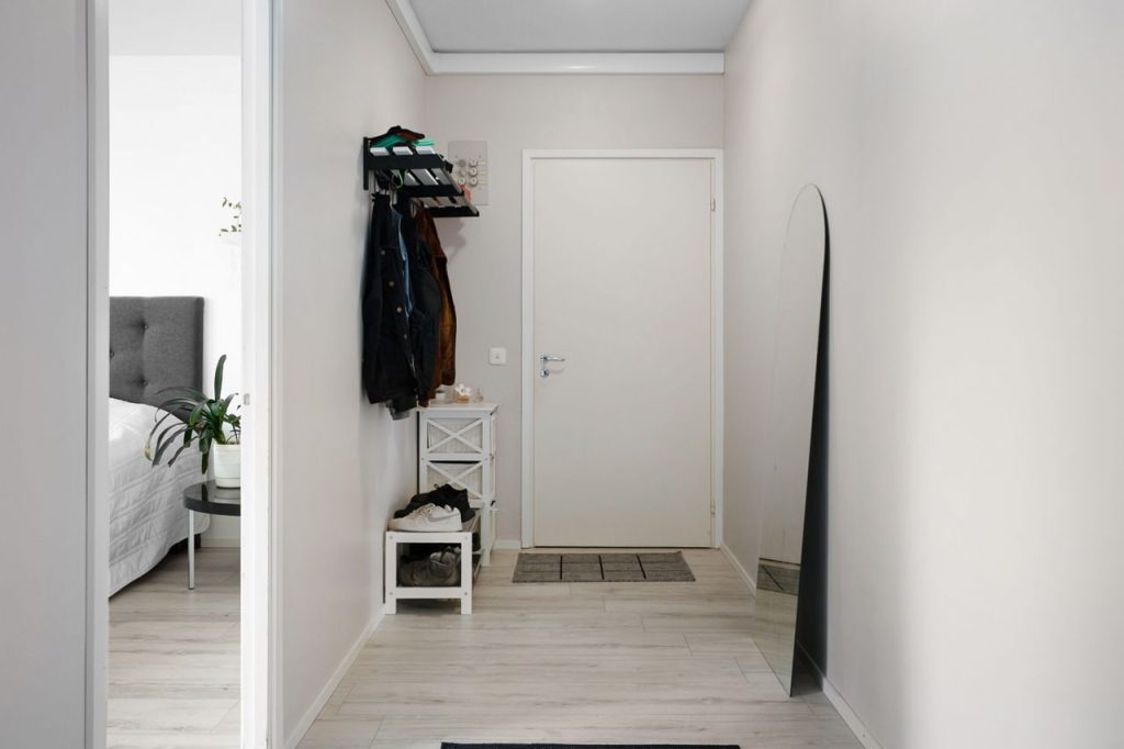 Bright entryway with coat rack and organized home storage