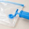 Manual pump connected to vacuum storage bag valve